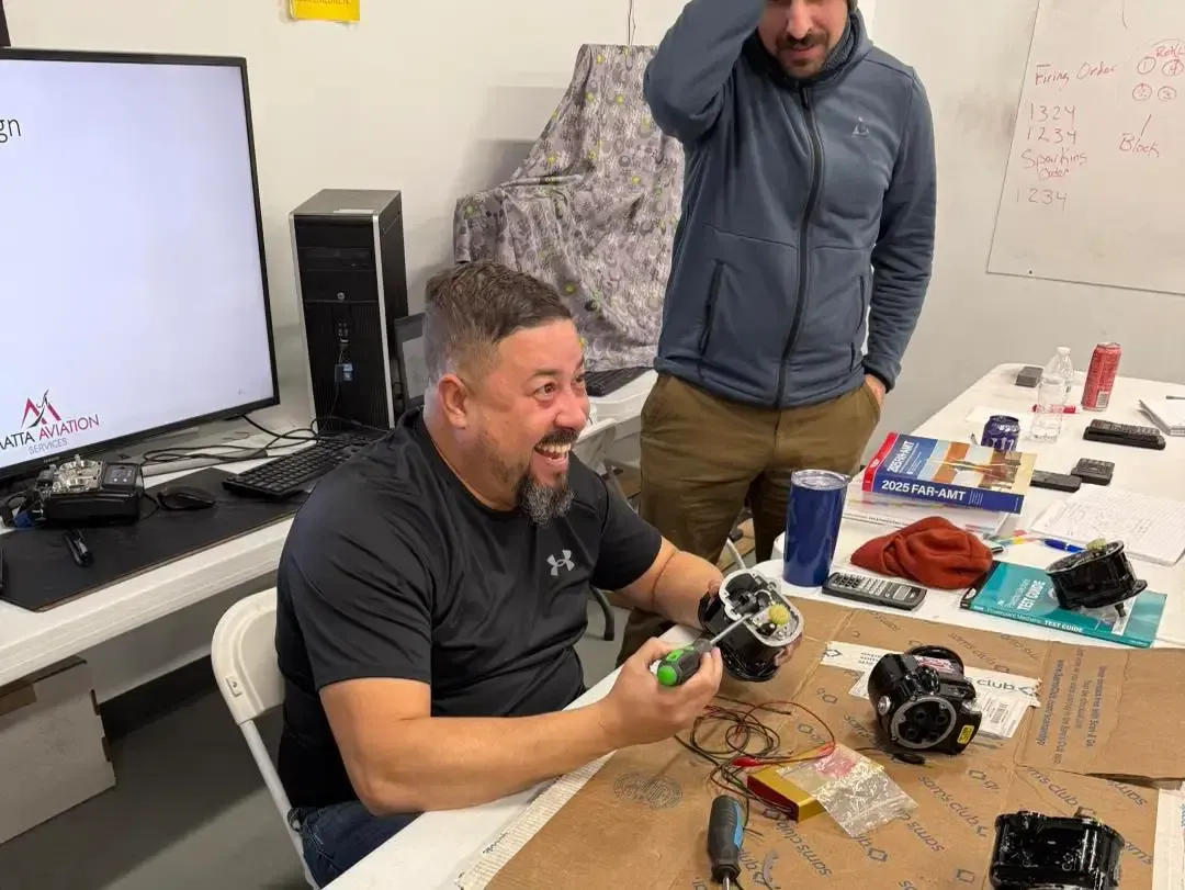 Instructor demonstrating aircraft components during hands-on A&P preparation