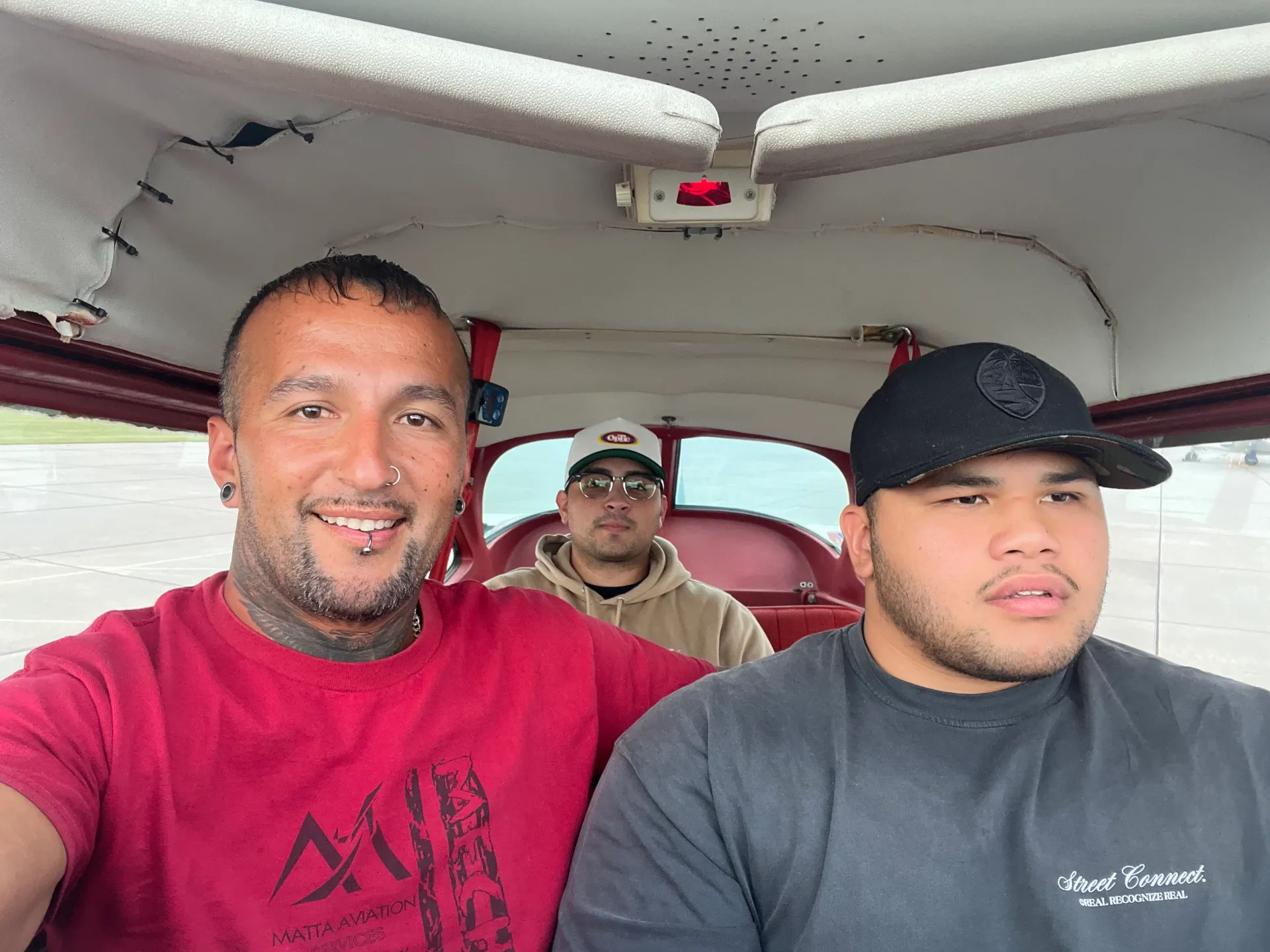 Eduardo Matta with students inside an aircraft